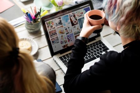 woman-hands-holding-coffee-cup-working-on-laptop-2025-02-10-05-49-13-utc