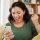 Phone, winning and celebrate, happy woman on sofa with notification on bonus, deal or discount offe.