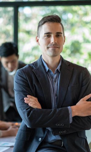portrait-of-a-smiling-handsome-businessman-with-cr-2025-01-10-05-29-27-utc-e1755849701972 (1)