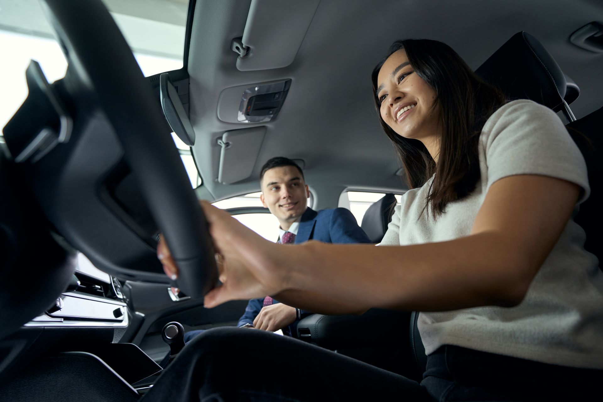 charming-woman-sits-behind-the-wheel-in-the-driver-2024-10-18-11-28-09-utc