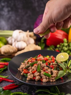 stir-fried-pork-basil-on-banana-leaves-in-a-black-2025-01-16-13-59-15-utc