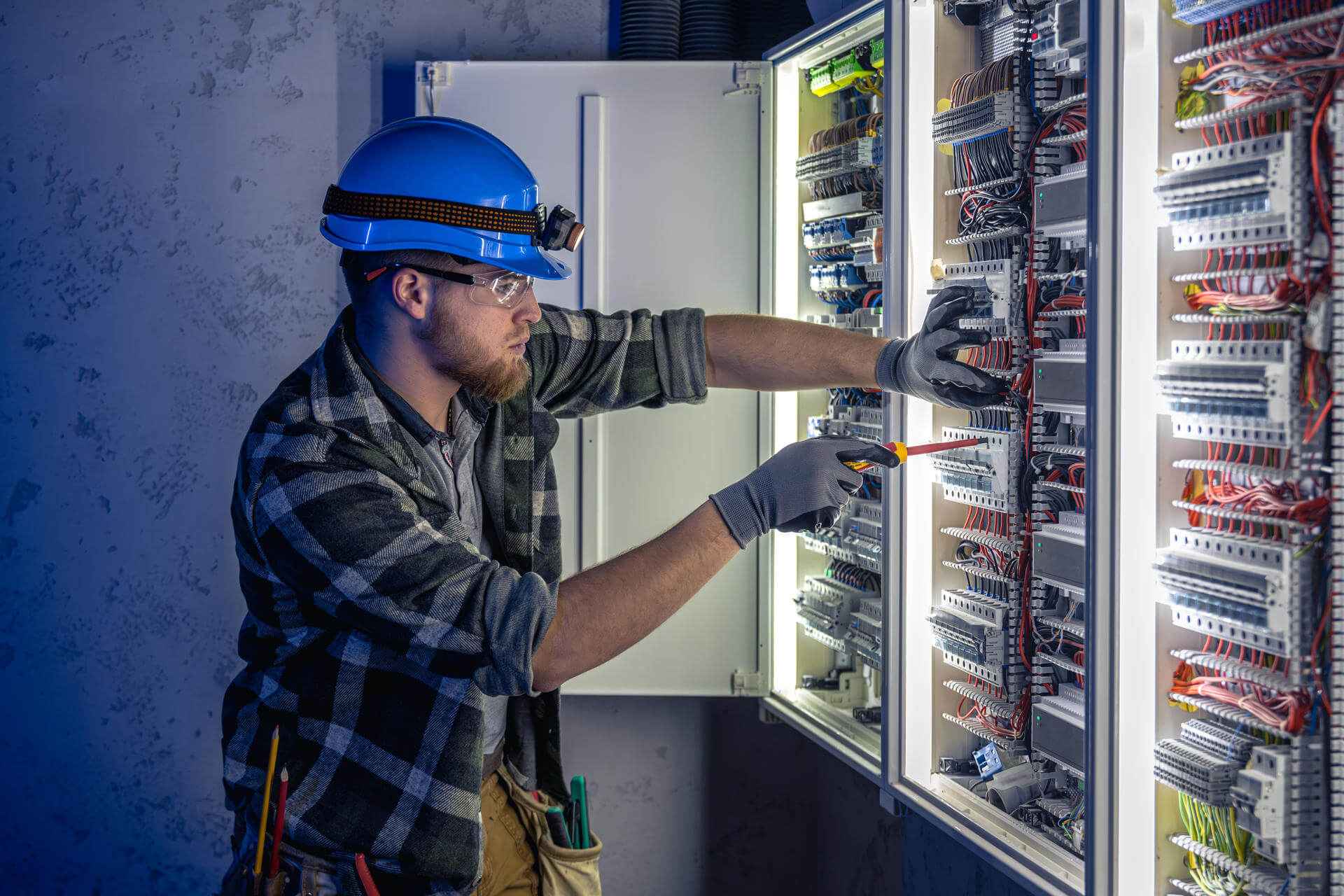 a-male-electrician-works-in-a-switchboard-in-overa-2025-03-16-16-43-45-utc_11zon