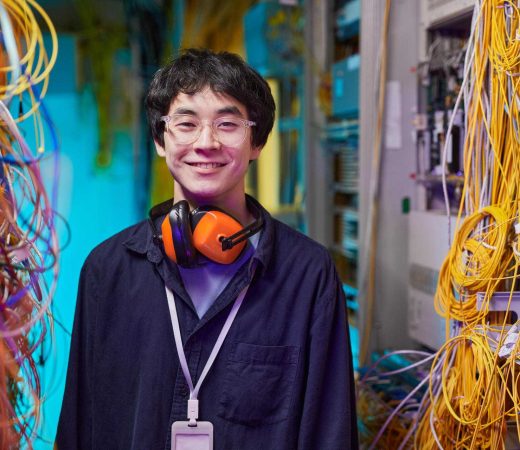 smiling-young-technician-in-server-room-2025-03-08-06-14-52-utc_11zon smiling-young-technician-in-server-room-2025-03-08-06-14-52-utc_11zon