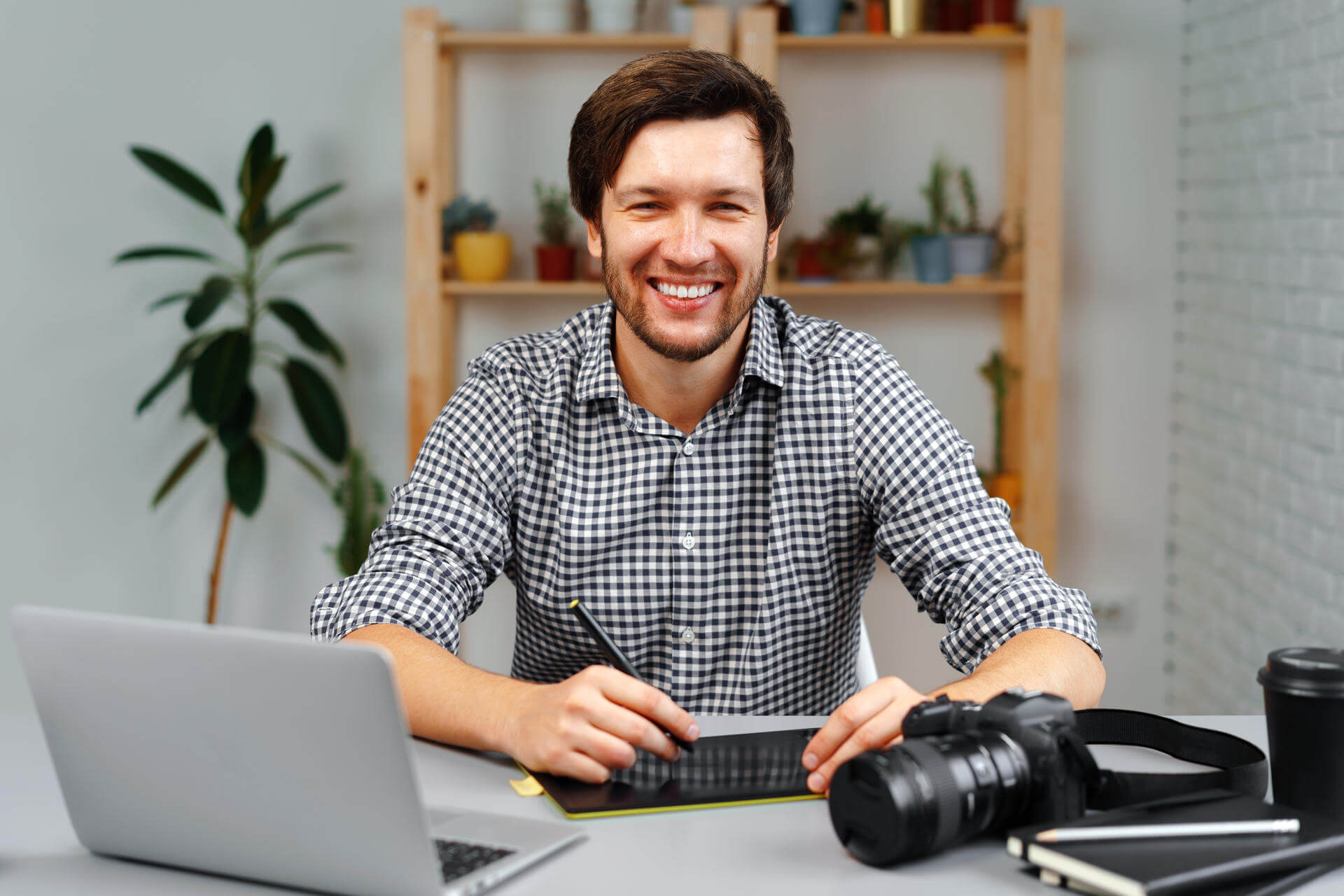 young-man-photographer-sits-at-table-and-works-fro-2025-02-24-20-05-58-utc young-man-photographer-sits-at-table-and-works-fro-2025-02-24-20-05-58-utc