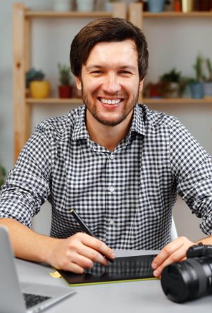 young-man-photographer-sits-at-table-and-works-fro-2025-02-24-20-05-58-utc