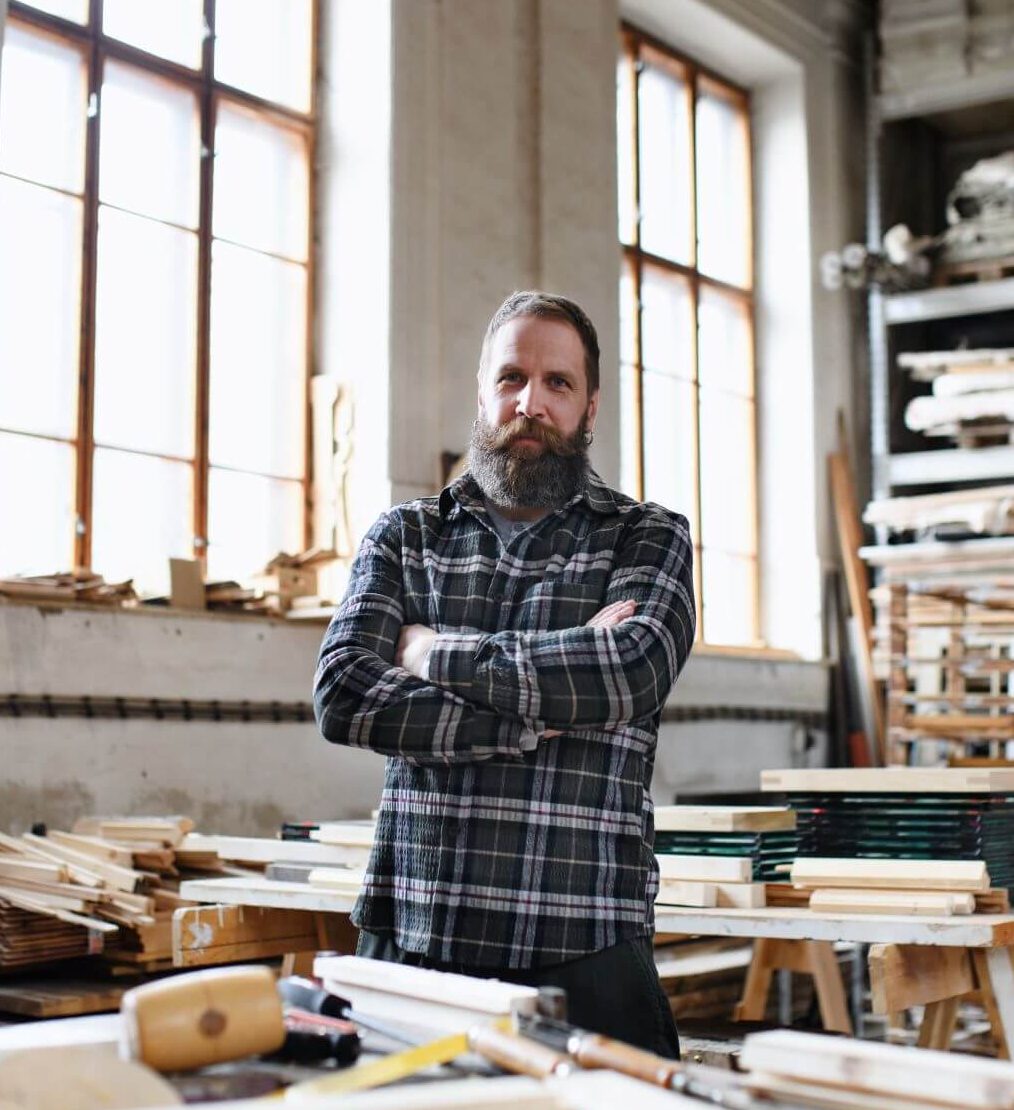 male-carpenter-with-arms-crossed-in-carpentery-wor-2024-10-22-05-17-16-utc