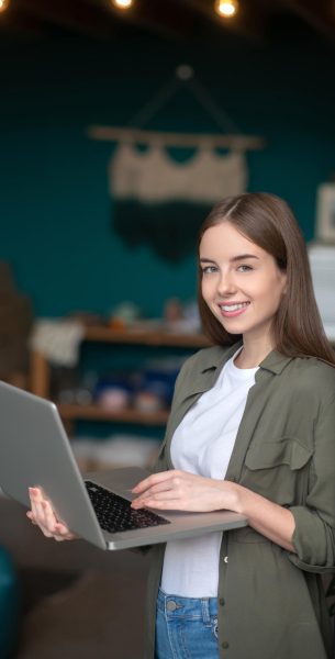 Young confident woman using her laptop for texting Typing a message. A young confident woman using her laptop for texting