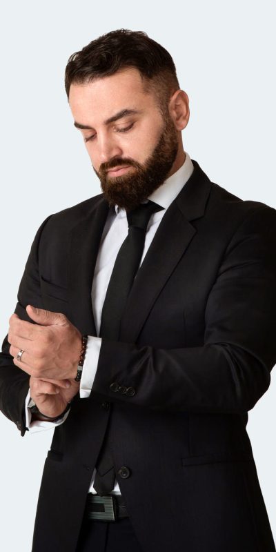 Serious entrepreneur wearing business suit on grey background Serious entrepreneur wearing business suit on light grey background
