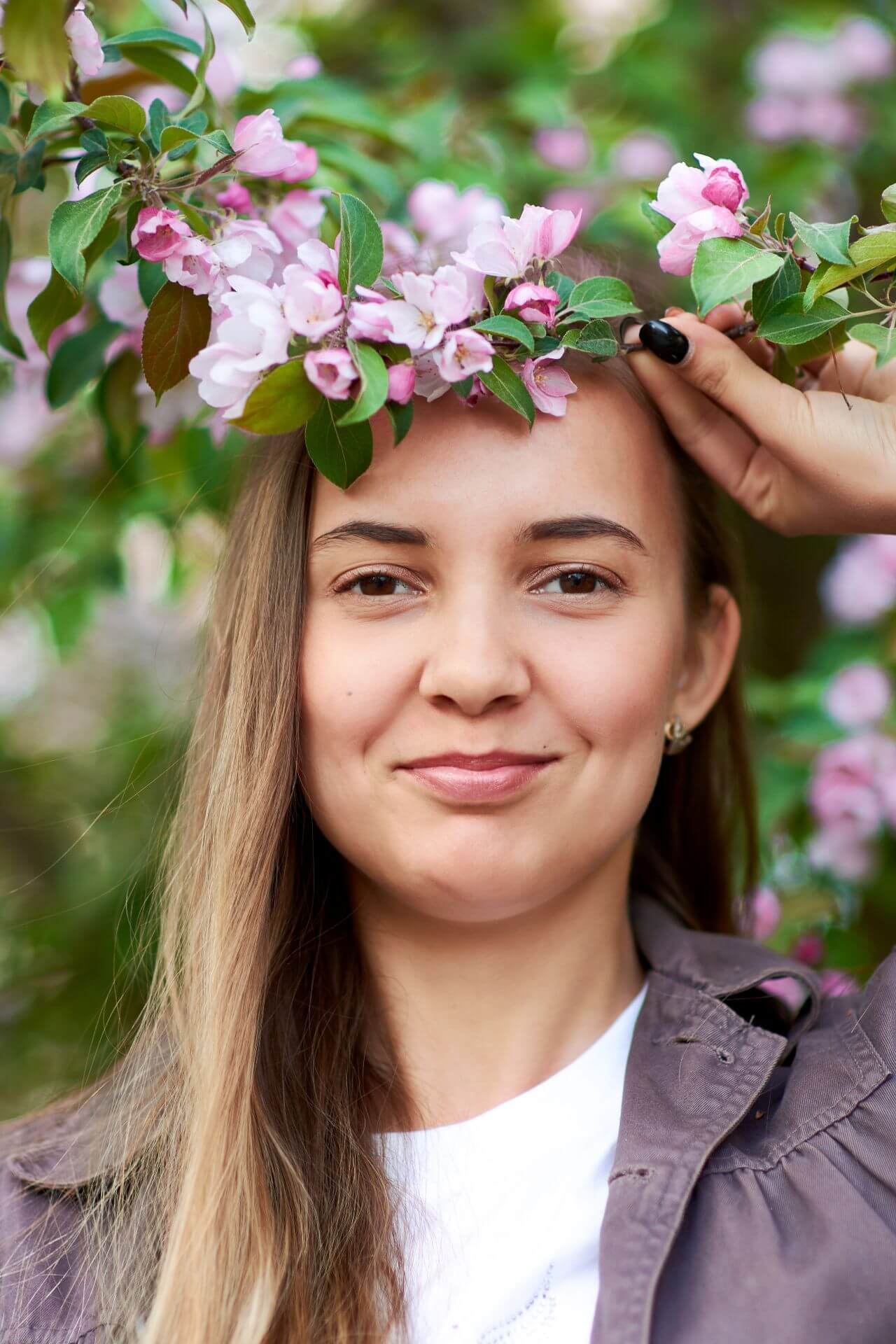 beautiful-young-woman-holds-a-branch-of-a-flowerin-2023-11-27-05-02-40-utc