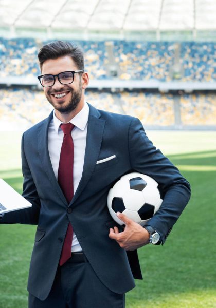smiling-young-businessman-in-suit-with-laptop-and-2024-11-19-15-53-33-utc