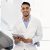 Modern Dentistry. Portrait Of Young Arab Male Stomatologist Using Digital Tablet At Workplace In Dental Clinic, Handsome Middle Eastern Dentist Waiting For Patient, Ready For Check Up, Copy Space