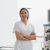 Smiling nurse in uniform standing in operating room on background of medical equipment