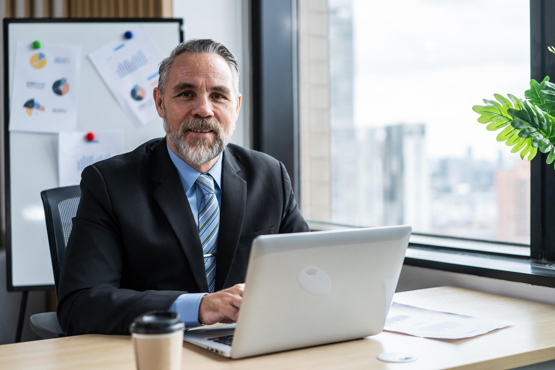 Portrait of Caucasian senior businessman working in office workplace. Attractive elderly mature male employee worker people sitting alone with confidence at company then smiling, looking at camera.