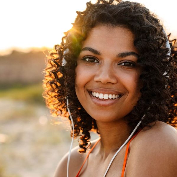 optimistic-young-african-woman-listening-music-2023-11-27-05-16-05-utc