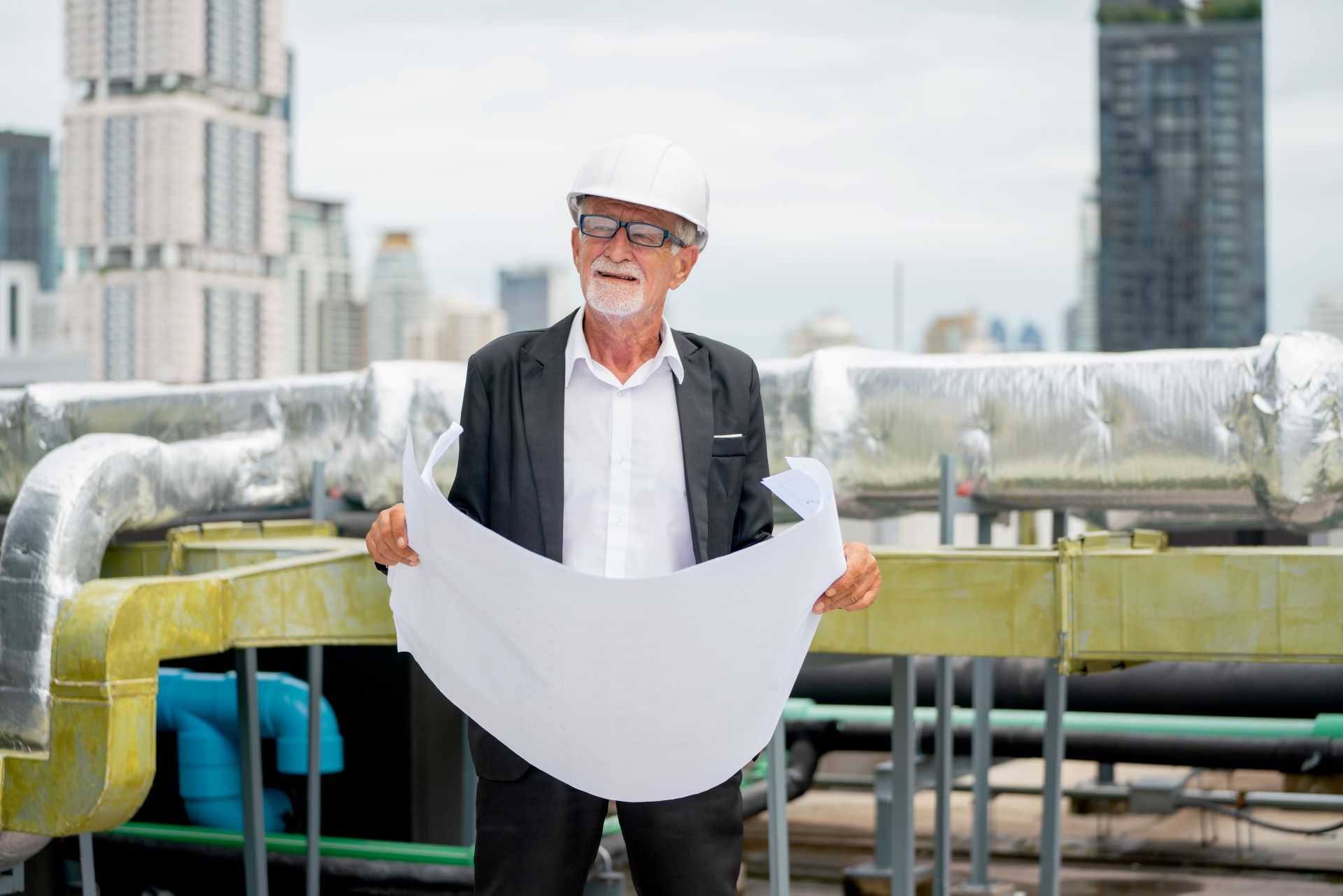 senior-engineer-man-hold-drawing-of-building-and-2025-03-09-01-02-42-utc