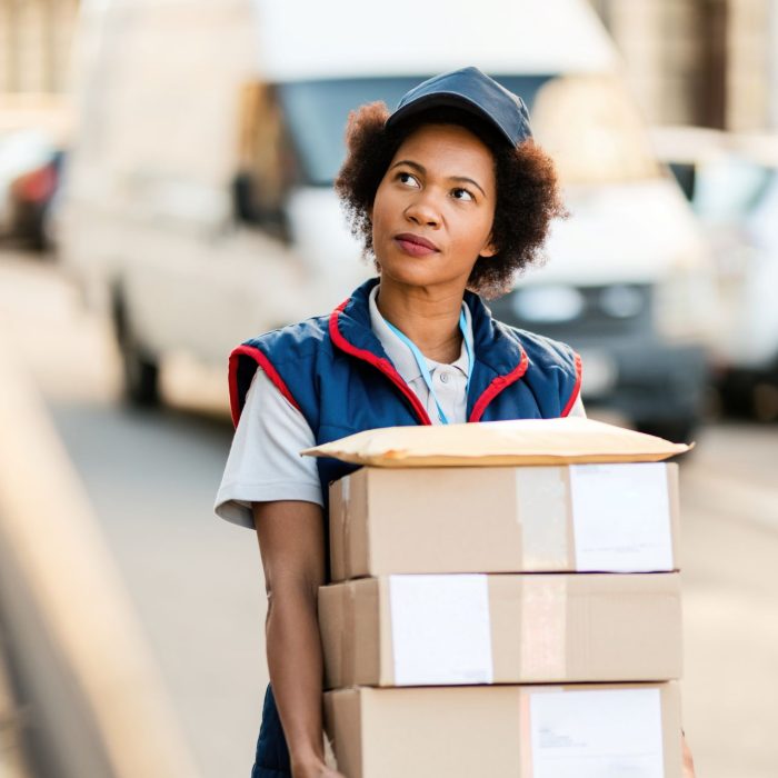 black-female-courier-carrying-packages-while-makin-2024-12-13-19-37-43-utc