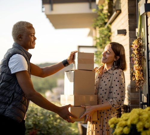 delivery-man-giving-parcels-to-caucasian-woman-2023-11-27-05-33-26-utc