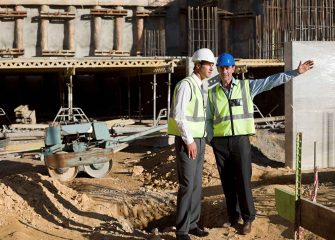 two-construction-workers-discussing-plans-on-site-2024-06-05-18-36-48-utc_11zon